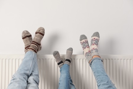 Family resting feet on the radiator