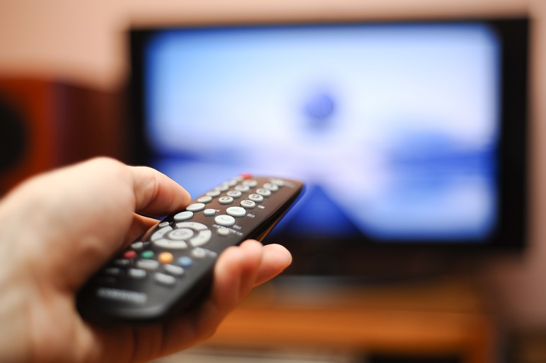 Cropped shot of a male hand pointing a remote control towards the TV